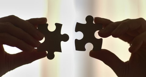 Two Hands Connect Couple Puzzle. One Part of Whole Symbol of Association and Connection. Close Up Hands of Woman Connecting Jigsaw Puzzle With Sunlight Affect. Business Solutions, Success Strategy. 