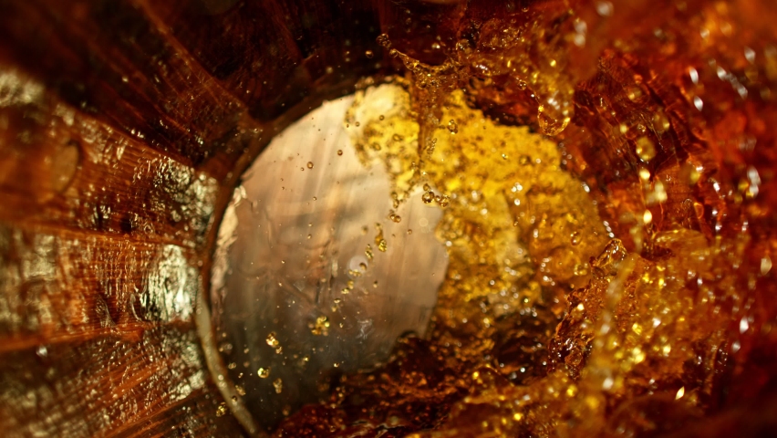 Super slow motion of pouring whiskey, rum or cognac inside the barrel. Filmed on high speed cinema camera, 1000fps. Ultimate composition view inside the wooden keg. Royalty-Free Stock Footage #1085665709