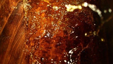 Super slow motion of pouring whiskey, rum or cognac inside the barrel. Filmed on high speed cinema camera, 1000fps. Ultimate composition view inside the wooden keg.