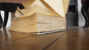 Old book falling to the floor in slow motion 180fps - Powered by Shutterstock - Get 15% off with code: PIKWIZARD15