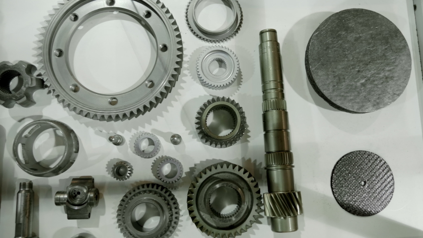 Metal parts of industrial equipment - shafts, gears - new spare parts in case of breakdown. Shot in motion. Closeup Royalty-Free Stock Footage #1085687486