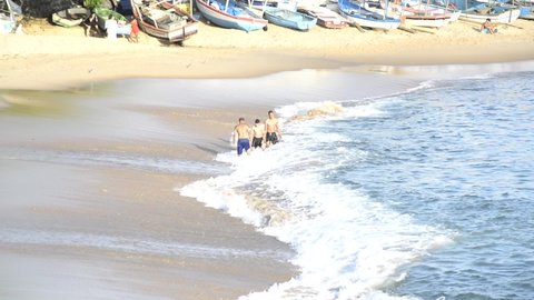 Salvador, Bahia, Brazil - September 05, 2021: People on the beach playing and bathing in the sea. Praia da Paciencia on the Rio Vermelho in Salvador, Bahia, Brazil.