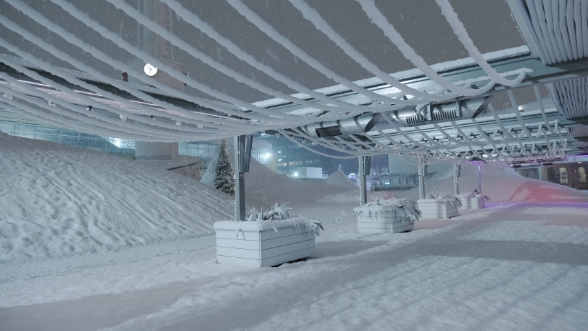 The heavy snowfall in the night in Helsinki, Finland. Snow-covered restaurant terrace.