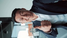 view of the front camera of a smartphone phone. Asian business man talking online on video call using smart mobile. Video meeting in the office. vertical video. portrait employee looking at camera - Powered by Shutterstock - Get 15% off with code: PIKWIZARD15