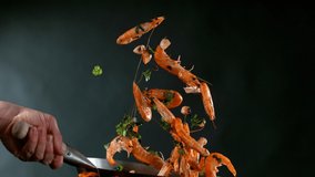Super slow motion of flying whole prawns from wok pan. Filmed on high speed cinema camera, 1000 fps. Speed ramp effect. - Powered by Shutterstock - Get 15% off with code: PIKWIZARD15