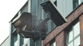 CCTV cameras monitor the street of the city and perform the function of an electronic access system by face ID. A polygonal closed-loop camera of a video surveillance system installed on a city street