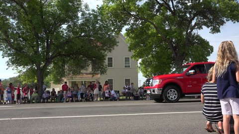 MORONI, UTAH - JUL 2015: Parade rural community junior princess float 4K. Small Community of Moroni celebrates the 4th of July by their annual parade. Family and friends gather along Main Street.