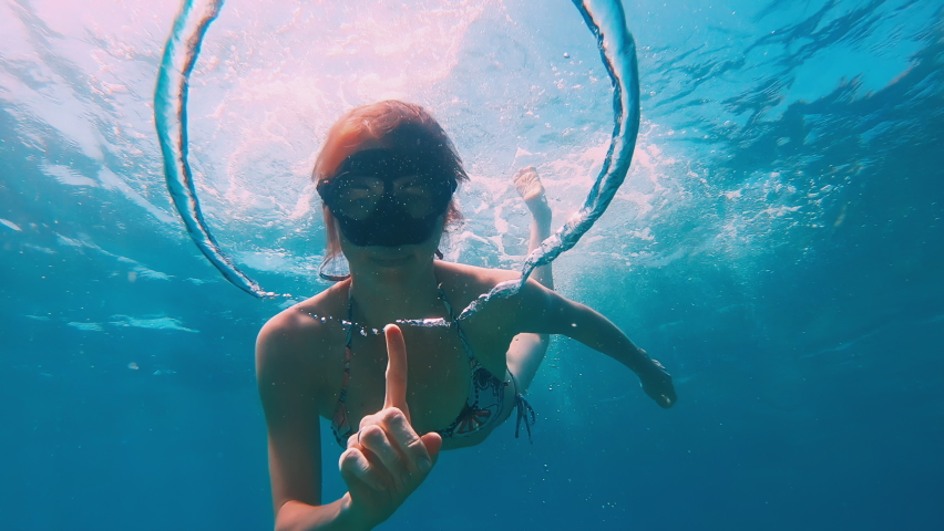 Bubble ring. Woman freediver plays underwater with bubble ring | Shutterstock HD Video #1085704511