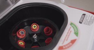 Blood sampling machine. Assistant puts blood sample tubes with specimens into centrifuge machine. - Powered by Shutterstock - Get 15% off with code: PIKWIZARD15