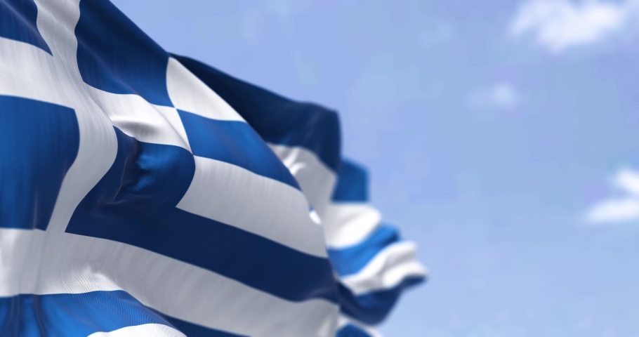 Detail of the national flag of Greece waving in the wind on a clear day. Democracy and politics. European country. Patriotism. Selective focus. Seamless Slow motion | Shutterstock HD Video #1085709608