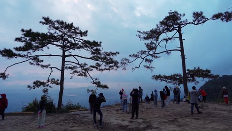 LOEI ,THAILAND - DEC 25, 2021 : Tourists looking with a nature view at Nok Aen Cliff on Phu Kradueng mountain national park. the famous travel destination.