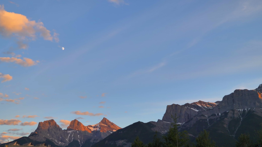 Wide Landscape of Dusk Sky Over Mountain Range With Moon Rising
