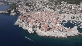 Video with a drone over Dubrovnik with a boat sailing and canoes on the water, flat-panel or dronie.