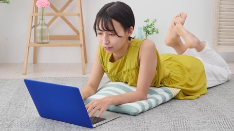 Asian woman using the laptop at home