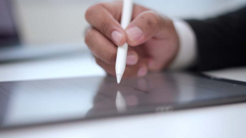 Close up businessman hand working electronic Signature on Tablet by Stylus. Write business agreement of contract. Man signing contract on tablet. Business and technology concept. Royalty-Free Stock Footage #1085718776