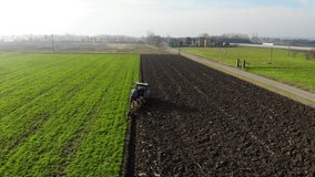 Video footage of a tractor plowing fields