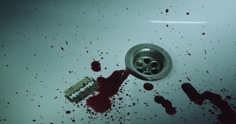 Blood and a razor being washed away in shower