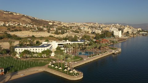 TIBERIAS, ISRAEL – DECEMBER 5 2021: Aerial view of water theme park and skyline of Tiberias, a popular holiday city and also an important religious destination, on the Sea of Galilee in Israel