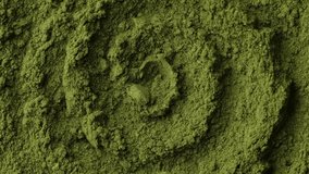 Superfoods matcha green tea powder or spirulina powder rotating. Green powder super food