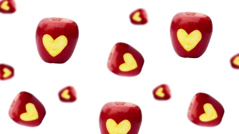 A stream of many different diameters apples with the inscription "i love you" and heart flying on a white color background. The Concept of St. Valentine's, weddings, birthday days and other holidays 