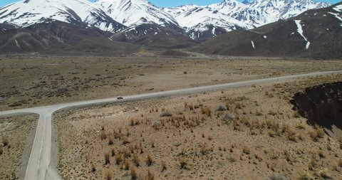 Aerial view of a car passing the edge of the Pozo de las ánimas (Well of the Soul). Located in Mendoza, Argentina.