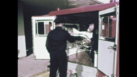 1970s: Men take female patient out of ambulance on stretcher. Smoke. Nurses help patients from bed. People work in lab.