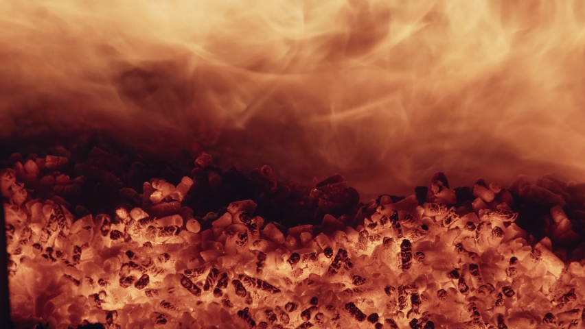 Close-up (dolly shot) of burning wood pellets in a boiler of a combined heat and power plant for municipal utilities. 4K
 | Shutterstock HD Video #1085748074