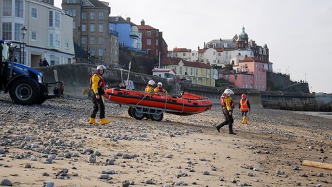 Cromer, Norfolk, United Kingdom. Circa May 2021. Cromer RNLI D-Class Inshore Lifeboat being launched from beach for training exercise.