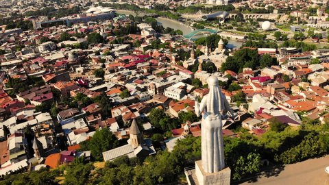 Cinematic aerial view to the Motherland statue in the Tbilisi. Georgia. Monument of the Motherland in Tbilisi, in the summer. Flying a drone around the famous monument motherland mother justice