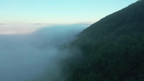 Great view of the valley covered with fluffy thick fog. Footage from a bird's eye view. Dniester canyon, Ukraine, Europe. Cinematic drone shot. Filmed in UHD 4k video. Discover the beauty of earth.