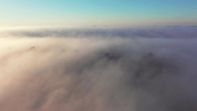 Fantastic view of the countryside covered with fog from a bird's eye view. Aerial footage of Dniester canyon, Ukraine, Europe. Cinematic drone shot. Filmed UHD 4k video. Discover the beauty of earth.