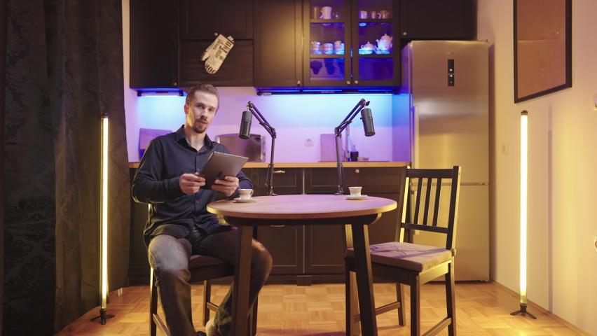 Host on live podcast introduce empty seat guest for round table discussion 4K