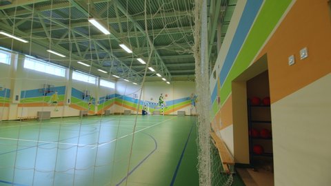 KAZAN, TATARSTAN RUSSIA - NOVEMBER 14 2021: Contemporary court for indoor football and basketball training with gate and pictures on wall at modern sports complex