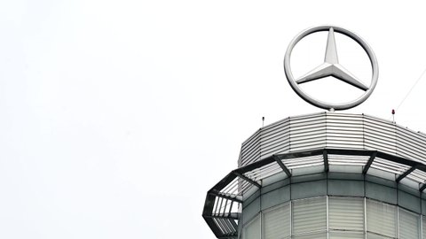 jakarta, indonesia on jan 17, 2022: defocused. Giant rotating Mercedes Benz emblem (sign, symbol) on top of the mercedes benz building, with copy space. selective focus