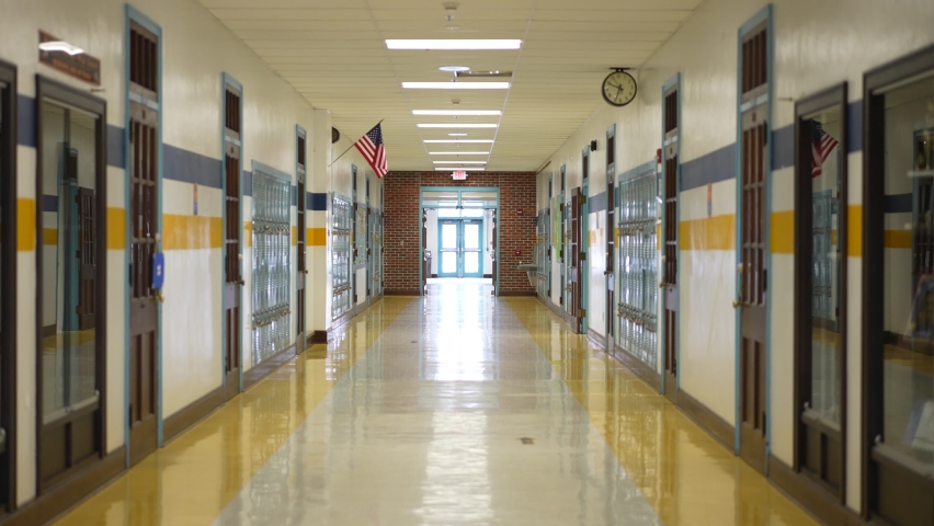 Berkeley Springs, WV, USA - 12 23 2021: Empty hallway in high, middle, or elementary school with all the lights on.