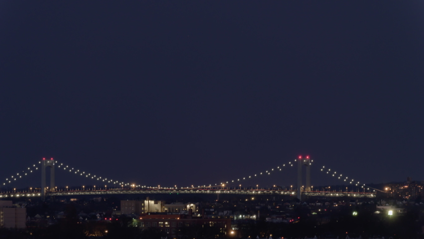 New York, NY, USA - Jan 18th 2022:  Moonrise Over Throgs Neck Bridge. This bridge connects Queens to the Bronx and opened on January 11, 1961, it is the newest bridge across the East River.
 Royalty-Free Stock Footage #1085768258