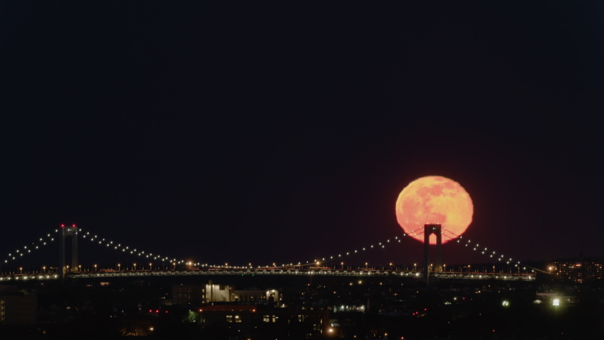 New York, NY, USA - Jan 18th 2022:  Moonrise Over Throgs Neck Bridge. This bridge connects Queens to the Bronx and opened on January 11, 1961, it is the newest bridge across the East River.
 | Shutterstock HD Video #1085768258