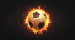 Rotating football ball in burning fire flames on dark background. Sport equipment as loopable 4K video background.