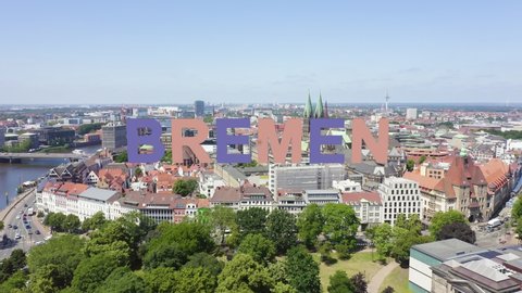 Inscription on video. Bremen, Germany. The historic part of Bremen, the old town. Bremen Cathedral ( St. Petri Dom Bremen ). View in flight. Multicolored text appears and disappears, Aerial View