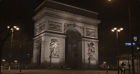 Paris, France - January 12 2022: a time-lapse video of traffic in front of Arch of Triumph (Arc de Triomphe) at night.