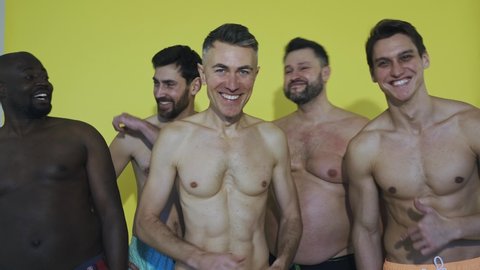 group of multiethnic men posing for a male edition body positive beauty set. Shirtless guys with different age, and body wearing boxers underwear