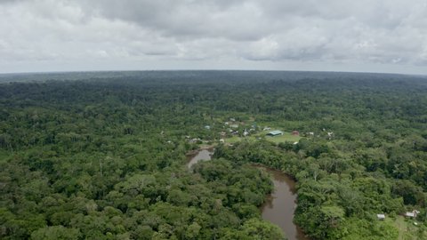 Aerial view of an indigenous community in the Amazon rainforest of Ecuador, this community lays along a river running through the tropical forest in Cuyabeno