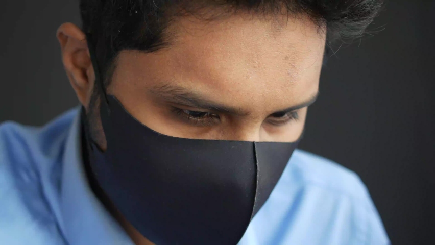 Close up of man with protective face mask taking deep breath 