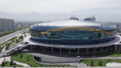Almaty, Kazakhstan - May 6, 2020: Flight over Almaty Arena on a bright sunny summer day. New sports facility in the city of Almaty. Wide aerial footage of two stadiums of Almaty Arena.