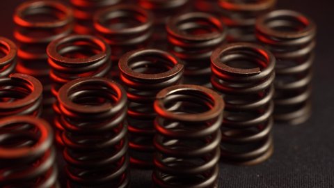 closeup of engine head spring, red reflections, for perfomance and tuning motor