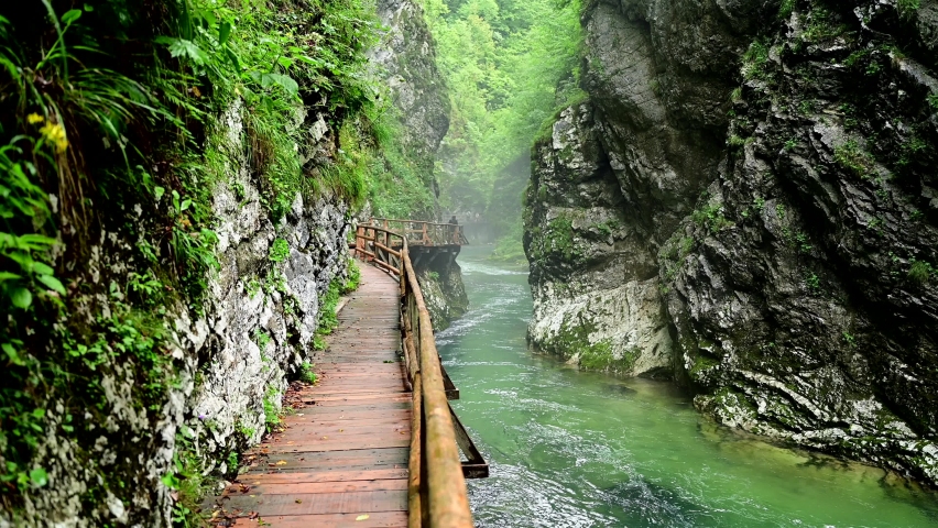 Wooden hiking trail along the clear green river through the Vintgar Gorge in Slovenia Royalty-Free Stock Footage #1085789237