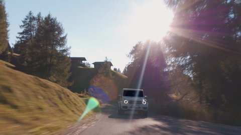 Alpe di Siusi, Dolomites-09.10.2021: Cinematic rolling shot of Mercedes Benz G Class SUV luxury sport car driving on a mountain road in Alpe di Siusi, Dolomites Mountain Alps, Italy 