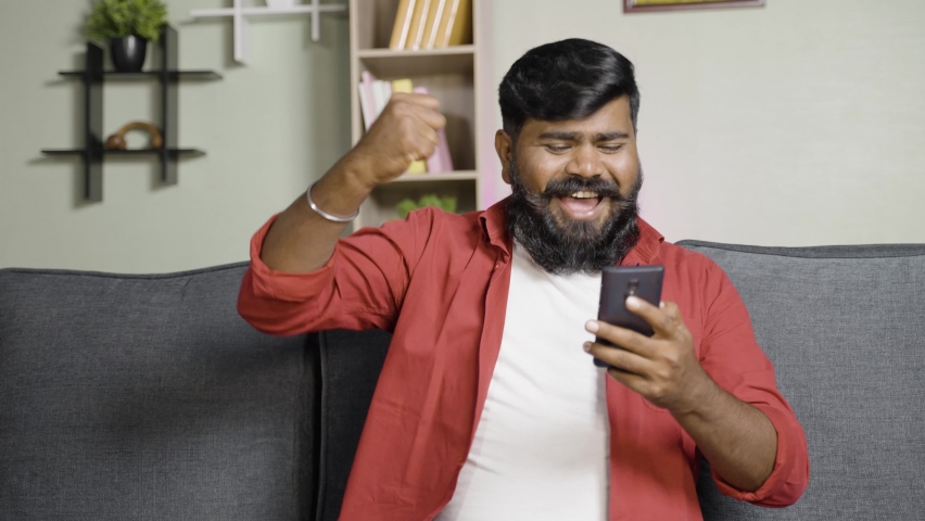 excited Indian beard man shouting and celebranting while using mobile phone - concept of new job offer, promotion and won betting game or lottery Royalty-Free Stock Footage #1085792609