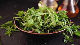 Mix salad greens. Arugula, lettuce, spinach in black bowl Video 4k