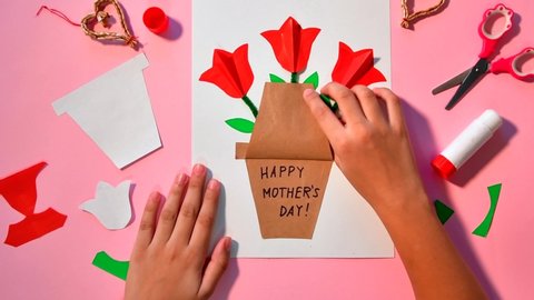 Children gift for Birthday or Mother's Day. Girl opening card for mother day. Easy paper applications.